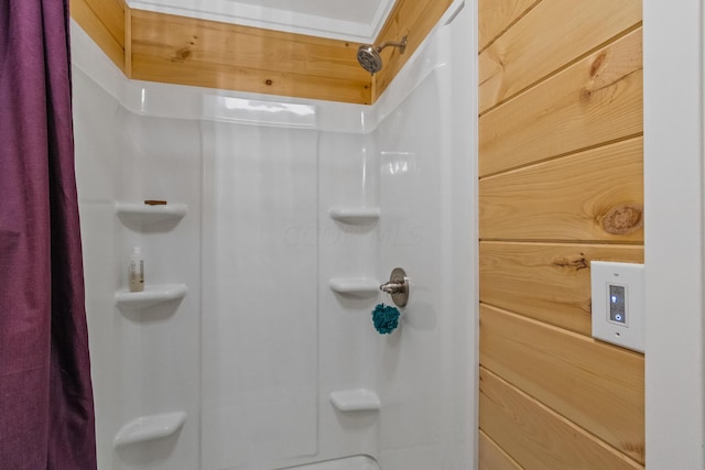 bathroom featuring a shower with curtain and wood walls