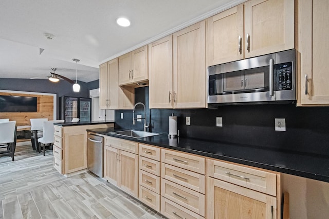 kitchen with light brown cabinets, sink, lofted ceiling, and stainless steel appliances