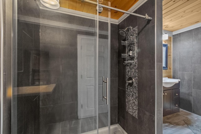 bathroom featuring vanity, tile walls, a shower with door, and wood ceiling