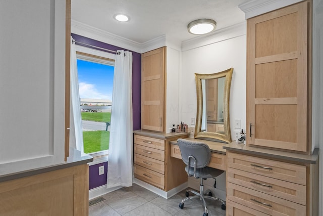 tiled home office with built in desk and ornamental molding