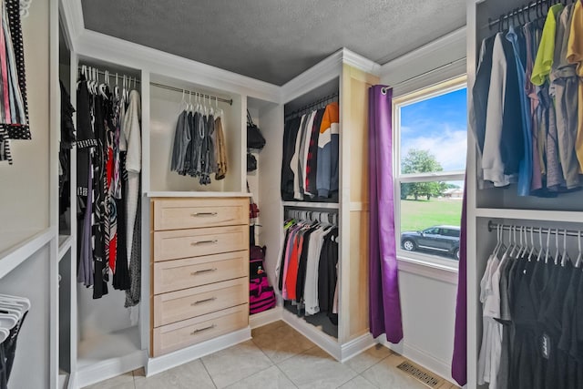 spacious closet with light tile patterned floors