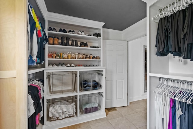 walk in closet with light tile patterned flooring