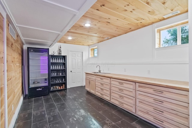 interior space with beverage cooler, wood ceiling, and wet bar