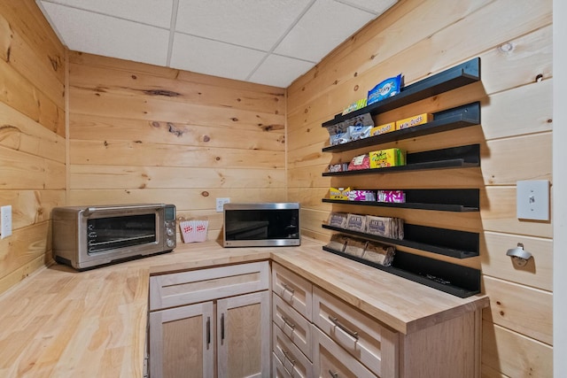 kitchen featuring wood walls, light hardwood / wood-style flooring, and wood counters