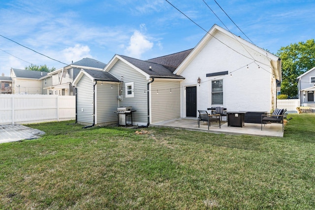 back of house featuring a yard and a patio area