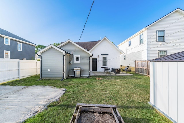 rear view of house featuring a yard, a storage shed, and a patio area