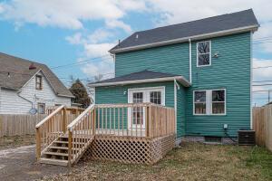 back of house with a deck