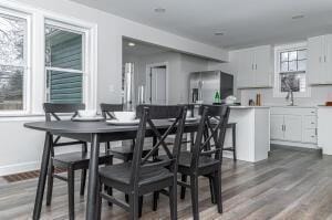 dining area with sink and dark wood-type flooring