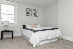 bedroom featuring light colored carpet