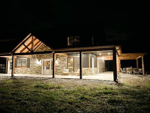 back house at night with a patio area