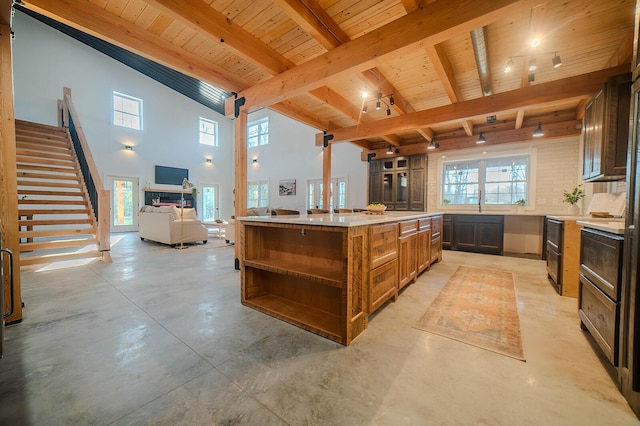 kitchen with beamed ceiling, a kitchen island, wooden ceiling, and high vaulted ceiling