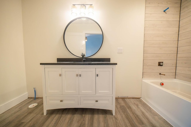 bathroom with vanity, wood-type flooring, and shower / bathtub combination