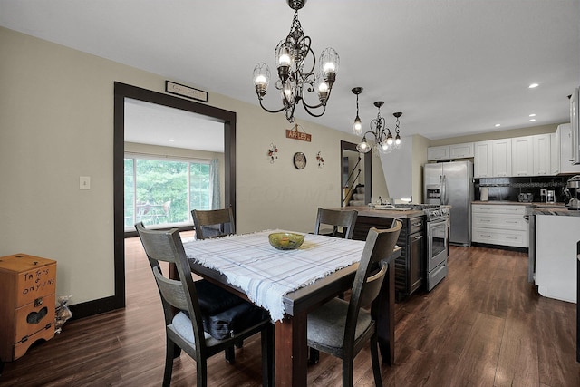 dining area featuring dark hardwood / wood-style floors and an inviting chandelier