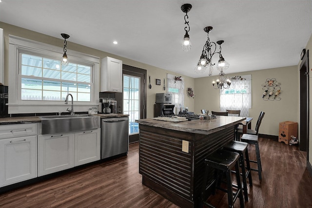 kitchen featuring white cabinets, a healthy amount of sunlight, pendant lighting, and dishwasher