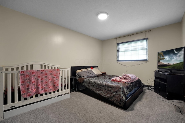 bedroom with carpet flooring and a textured ceiling