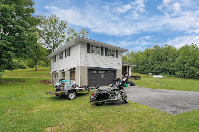 view of front of house with a garage and a front lawn