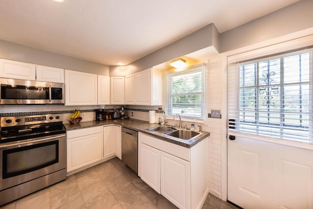 kitchen with white cabinets, stainless steel appliances, and sink