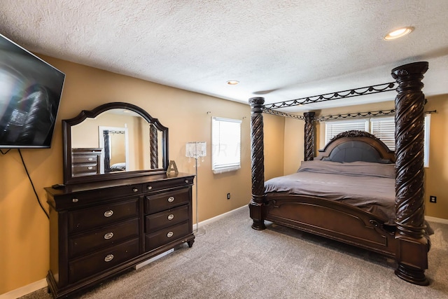 bedroom with light carpet and a textured ceiling