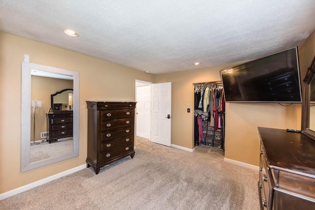 carpeted bedroom with a textured ceiling