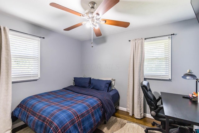 bedroom featuring ceiling fan and dark wood-type flooring