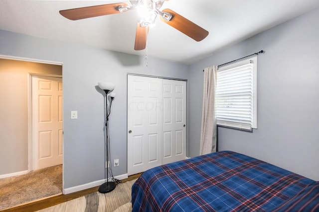 bedroom with ceiling fan, a closet, and hardwood / wood-style flooring