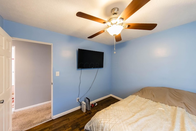 bedroom featuring ceiling fan and dark hardwood / wood-style floors