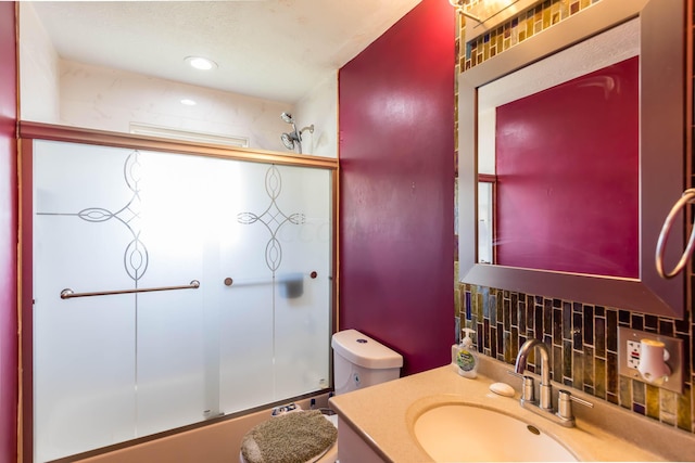 full bathroom with vanity, toilet, and bath / shower combo with glass door