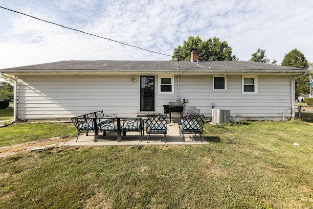 back of property with a patio, central AC, and a lawn