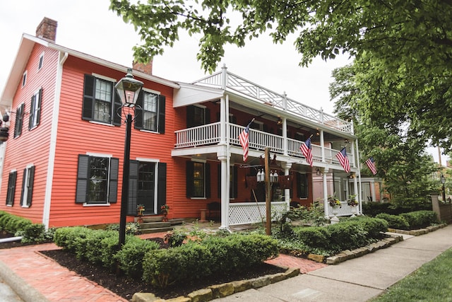 view of front of house featuring a balcony