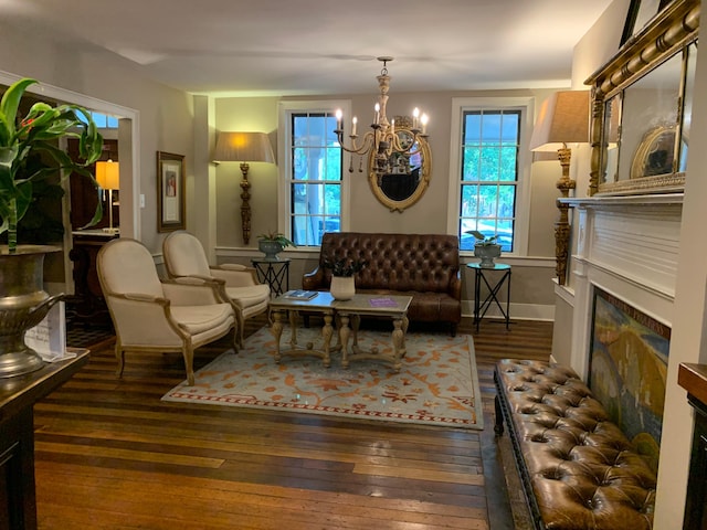 living room featuring a chandelier, a high end fireplace, and dark wood-type flooring