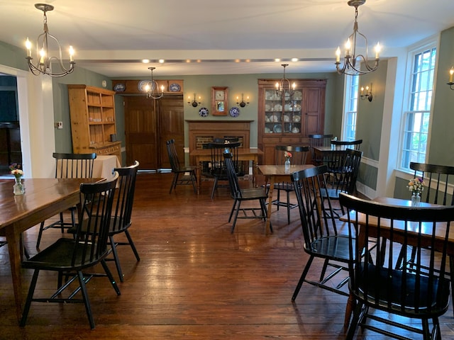 dining space featuring a notable chandelier and dark hardwood / wood-style floors