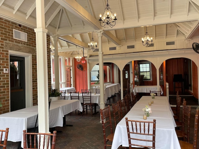 dining area with beam ceiling, ornate columns, and high vaulted ceiling