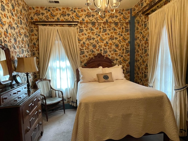 bedroom with carpet flooring and a chandelier