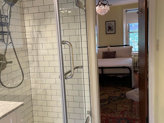 bathroom with a shower with shower door and an inviting chandelier