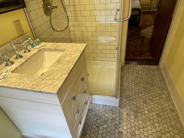 bathroom with tile patterned flooring, vanity, and an enclosed shower