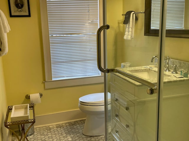 bathroom featuring tile patterned flooring, vanity, and toilet