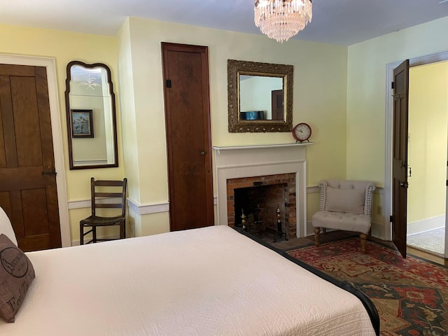 bedroom featuring a fireplace and a notable chandelier