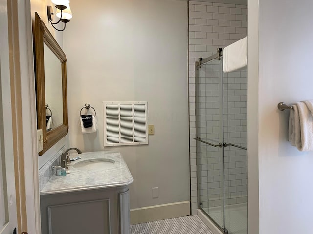 bathroom with tile patterned flooring, vanity, and a shower with shower door