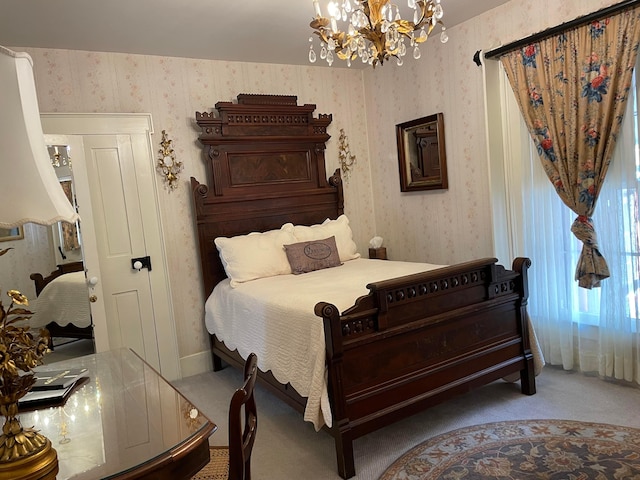 carpeted bedroom featuring an inviting chandelier