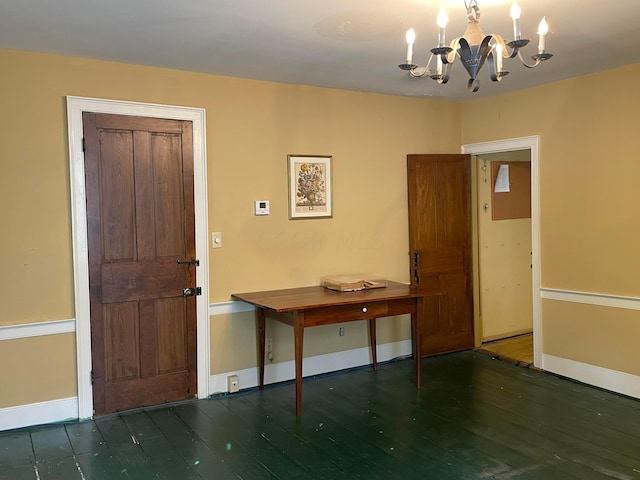 foyer featuring an inviting chandelier and dark wood-type flooring