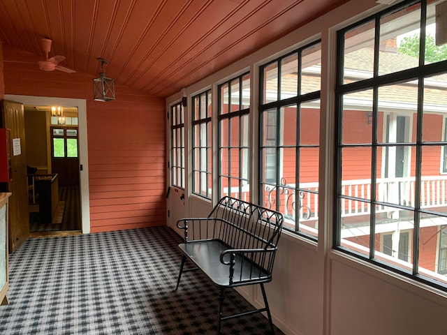 sunroom / solarium featuring plenty of natural light, wooden ceiling, and vaulted ceiling