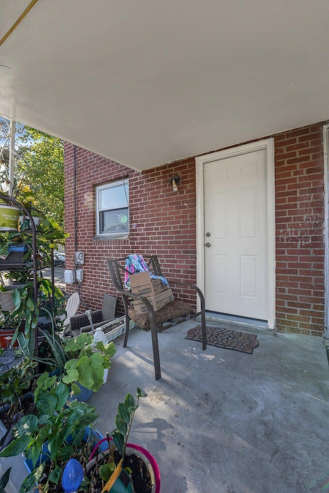 view of exterior entry featuring a patio