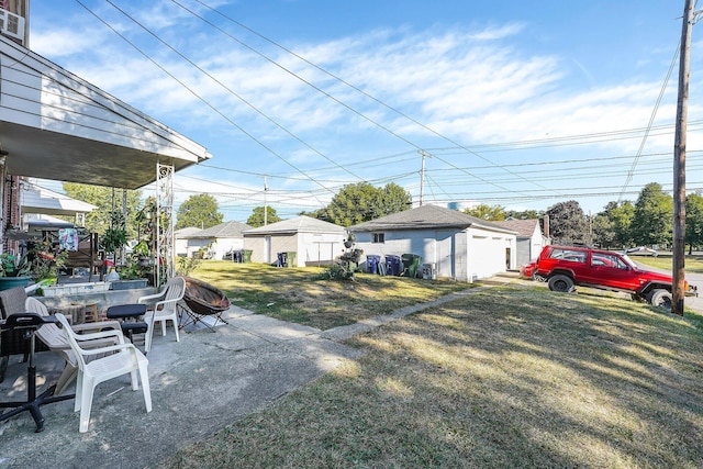 view of yard with an outbuilding and a patio