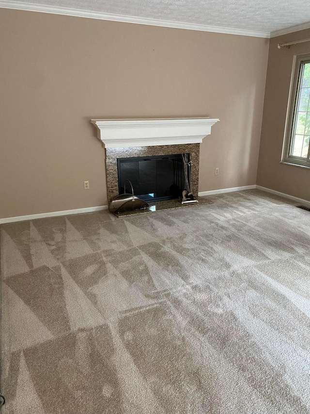 interior details with a textured ceiling, carpet floors, and crown molding