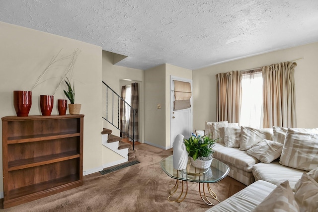 living room featuring carpet and a textured ceiling