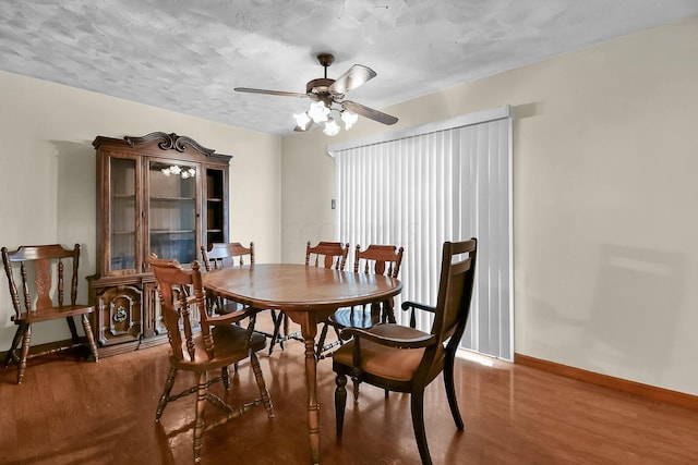 dining space with a textured ceiling, dark hardwood / wood-style floors, and ceiling fan