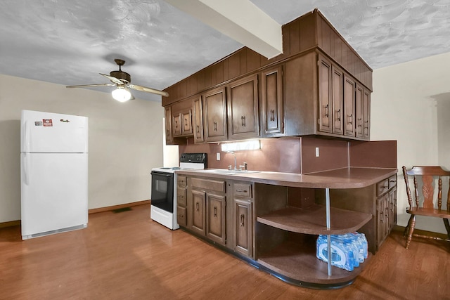 kitchen with white appliances, sink, ceiling fan, light wood-type flooring, and dark brown cabinets