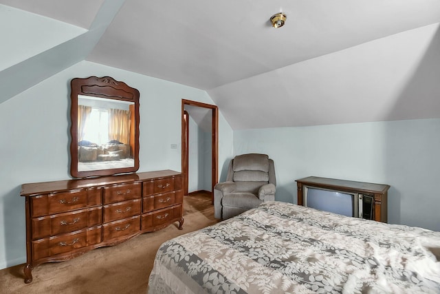 bedroom with light colored carpet and lofted ceiling