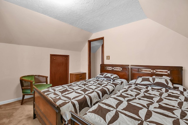 carpeted bedroom with lofted ceiling and a textured ceiling