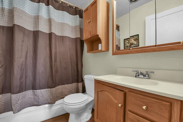 bathroom featuring a textured ceiling, vanity, toilet, and a shower with curtain